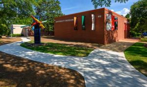 The front exterior of the UM Museum. Front Lawn has a brightly colored sculpture